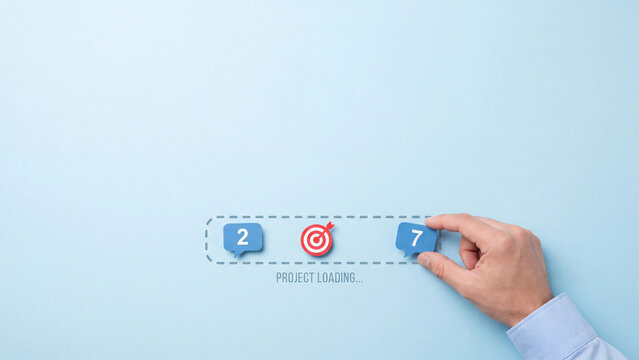 Project loading progress bar on blue background with target icon and numeric labels managed by hand.