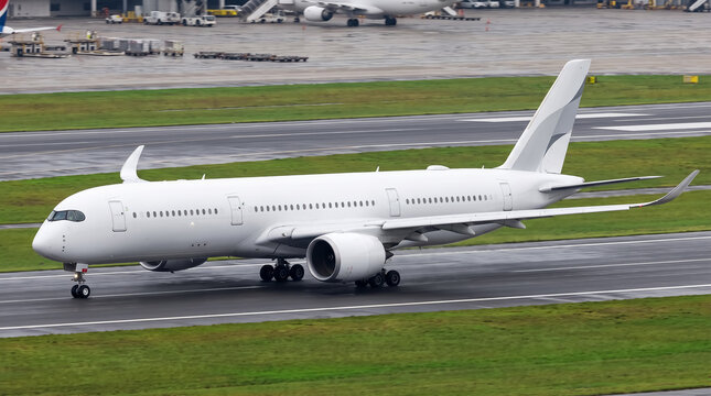 Modern airbus A350 xwb passenger jet airplane taxiing on airport runway featuring winglets and white fuselage for luxury air travel transport.