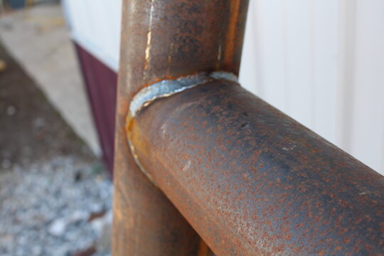 Close up of a weld bead joining two rusty steel pipes