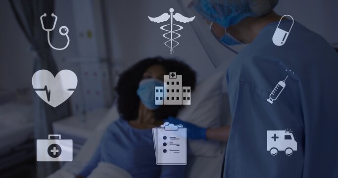 Helping clinician touching patient shoulder at hospital bed, wearing scrubs, mask, gloves, icons