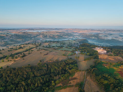 Beautiful drone landscape image over Stanton Moor in Summer Heather sunrise