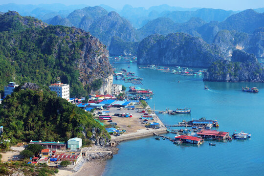 High angle view of Ben Beo harbor and Cai Beo floating village surrounded by limestone karst mountains on Cat Ba Island, Vietnam.