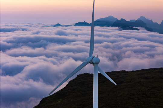 Wind turbine rotor above clouds, Madeira island. Transition to low carbon energy system and renewable sources
