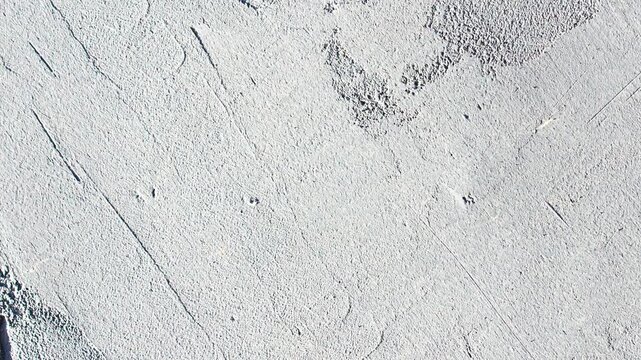 A plastered wall. Gray, rough, grunge-style plaster the surface of a wall inside a room a background, animation