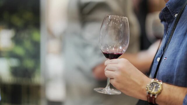 Sommelier holding and swirling a red wine glass