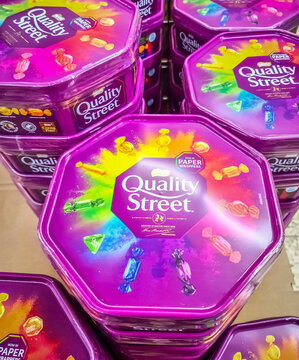 Kiel, Germany - 08 August 2024: Numerous purple tins of Quality Street brand praline mix for sale in a store.