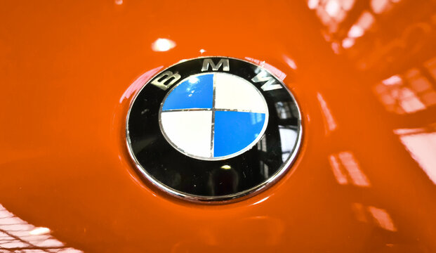 Kiel, Germany - 25. September 2025: BMW Roundel emblem on red car surface