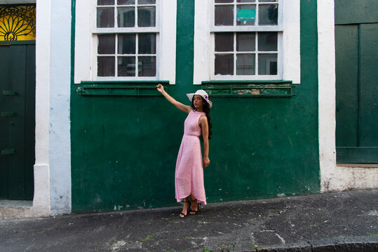 Woman in a Pink Dress and White Hat