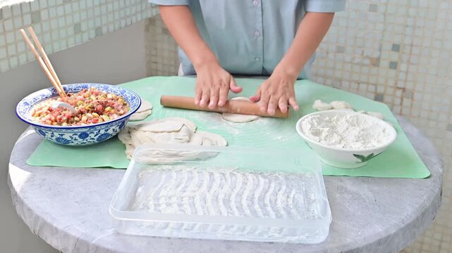 Housewife making dumplings by hand at home