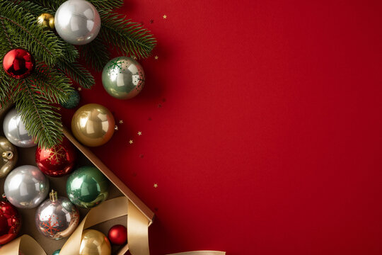 Merry Christmas and Happy New Year red background with ornaments, ribbon and fir branch