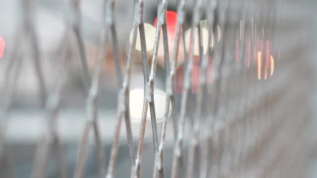 Traffic Lights Behind Chain Link Fence at Dusk
