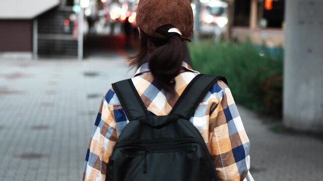 Woman Walking Through City Street at Dusk Rear View Slow Motion