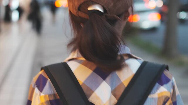 Woman Walking Through City Street at Dusk Rear View Slow Motion