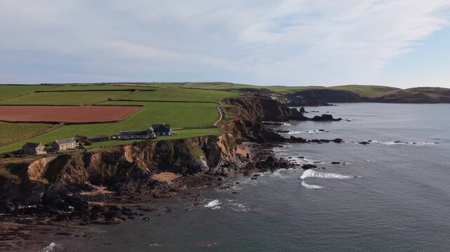 Aerial drone footage of South Milton Sands in South Devon, showcasing the sandy beach, turquoise coastal waters, rugged shoreline and scenic landscape of the English coast