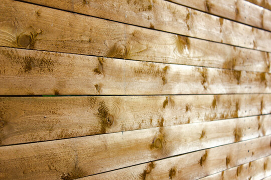 A fence made of wooden planks. Authentic wooden planks, a barrier.