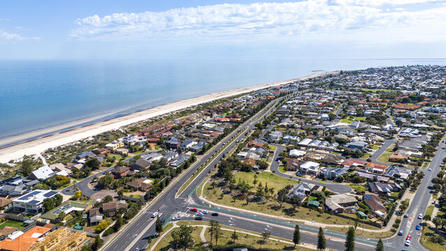 A wide aerial&nbsp;drone view of &nbsp;the coastal suburb of West Lakes Shore, Adelaide, South Australia,&nbsp;with coastal roads, low-density residential streets, vegetated sand dunes, and the expansive sandy beach