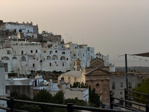 Scenic and panoramic view of the charming historic center of Ostuni, known as the "White City" (Citt Bianca), featuring traditional whitewashed houses, narrow alleys, and Mediterranean architecture pe