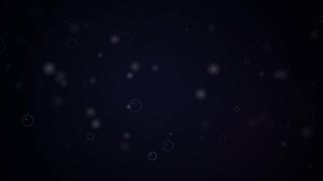 A digital animation features soft translucent circular outlines and glowing bokeh light particles floating gently across a deep dark background, creating a calm and ethereal atmosphere.