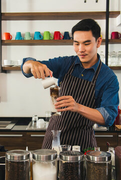 Vertical Horizon Portrait barista Asian man coffee shop smiling look at camera. confident Small business owner Entrepreneur manager men standing coffee counter bar. Vertical Barista small business