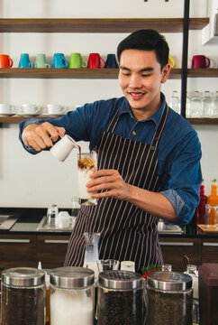 Vertical Horizon Portrait barista Asian man coffee shop smiling look at camera. confident Small business owner Entrepreneur manager men standing coffee counter bar. Vertical Barista small business