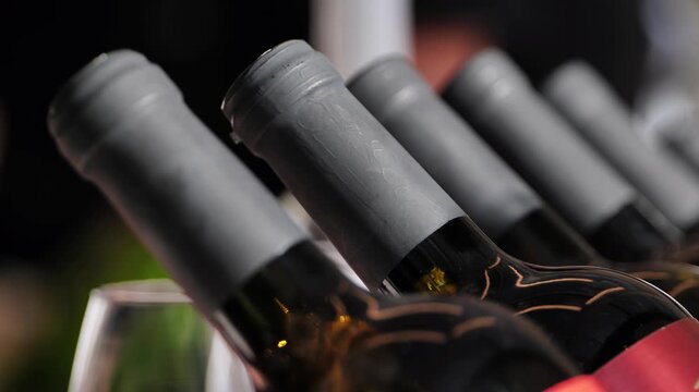 Wine bottles with grey capsules stored in rows, ready for consumption