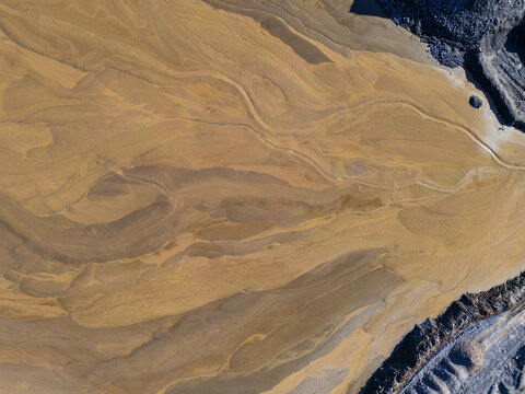 Aerial view of intricate sediment patterns and sandy textures in a quarry in Rathmore, County Kildare, Ireland.