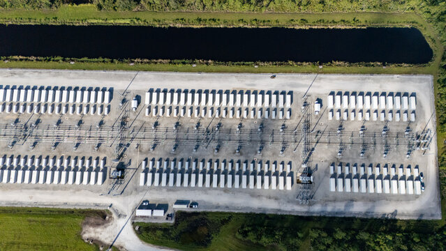 Aerial view of the FPL Manatee Energy Storage Center, featuring rows of white battery containers and electrical infrastructure in Parrish, Florida, United States.