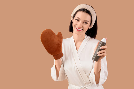 Self tanning and skincare routine, woman in bathrobe holding tanning mousse and applicator mitt for sunless tan application on beige background