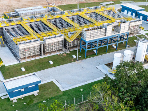 Aerial view of a modern modular stainless steel water treatment plant featuring flocculation, decantation, and filtration tanks with yellow walkways.