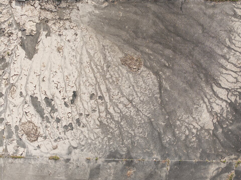 Aerial view of the Brushy Creek Wastewater Treatment Plant showing textured sediment patterns and industrial surfaces in Chirnside Park, Victoria, Australia.