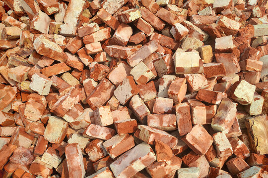 Large pile of broken red clay bricks