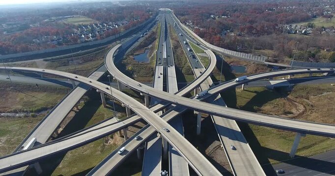Aerial view of a multilevel highway stack interchange with traffic in autumn near Baltimore