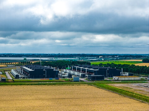 Aerial view of Agriport A7 data center campus with large industrial buildings surrounded by agricultural fields in Middenmeer, Noord-Holland, Netherlands.