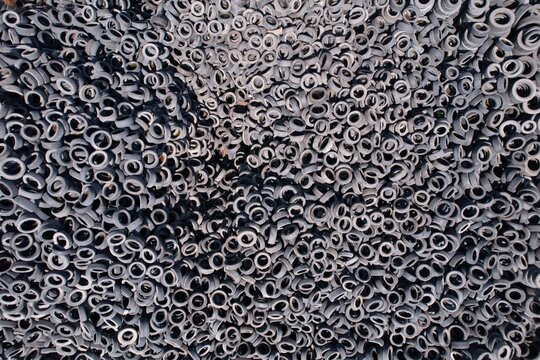 Aerial view of a massive pile of discarded rubber tires stacked in a large industrial area in Tbilisi, Tbilisi, Georgia.