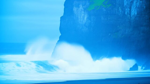 Waves exploding around a sea stack