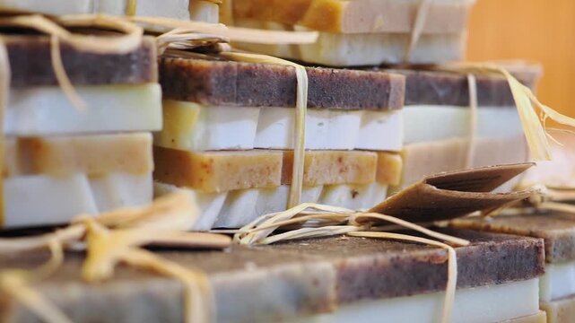 Handmade soap bars stacked and tied with string in a workshop