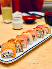 Assorted Japanese Sushi Rolls with Salmon on a White Plate in a Restaurant © Irfan
