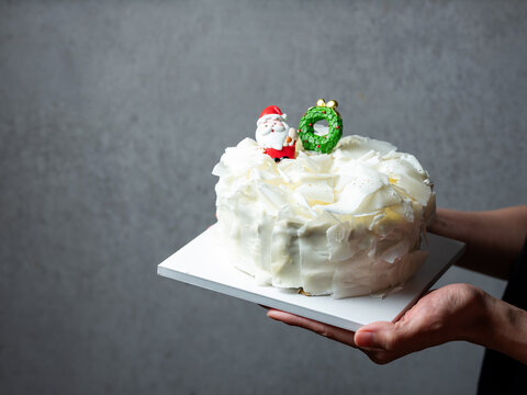 festive Christmas white chocolate curl cake decorated with Santa and Xmas tree figures
