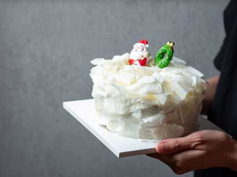 festive Christmas white chocolate curl cake decorated with Santa and Xmas tree figures