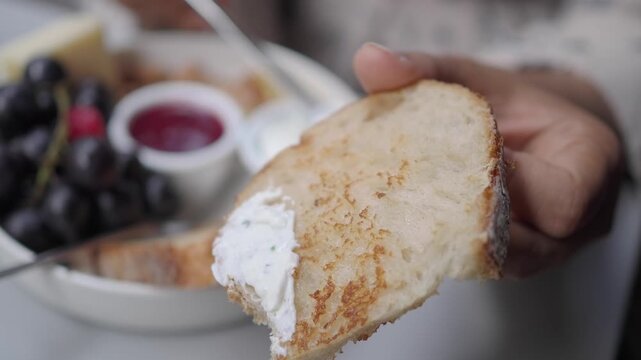 Spreading Cream Cheese on Toasted Bread