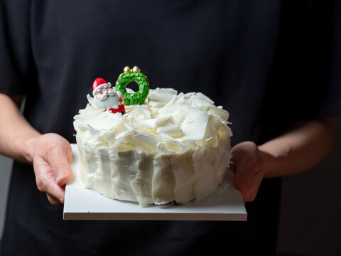 festive Christmas white chocolate curl cake decorated with Santa and Xmas tree figures