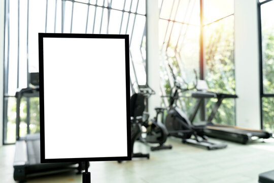 Empty whiteboard in bright, airy gym with exercise machines
