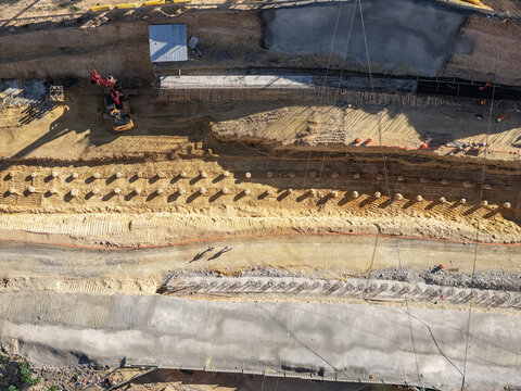 Aerial view of construction work on Avenida Republica de Colombia with concrete piles, excavation, and heavy machinery in Santo Domingo, Distrito Nacional, Dominican Republic.