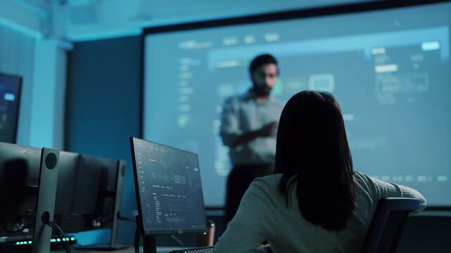 Software meeting question and answer, woman raising hand as developer presents project