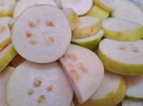 Fresh sliced white guava fruit pieces arranged in a pile for healthy