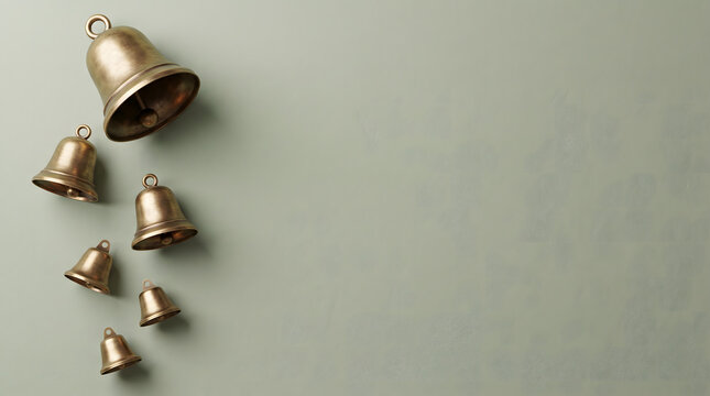 A collection of antique brass bells hanging in a vertical line on a neutral background