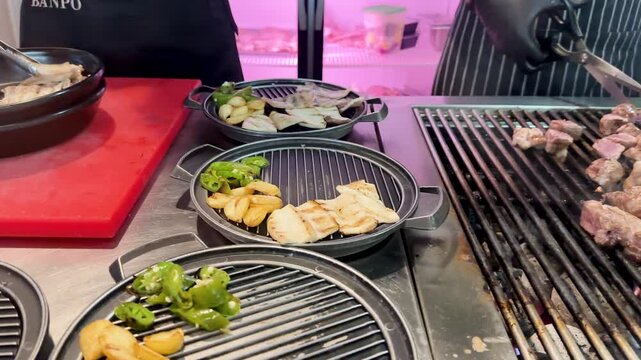 Chef Grilling and Cutting Pork Belly at Korean Barbecue Restaurant