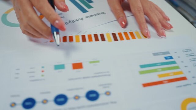 Close up young Asian woman reviews financial documents and writes budget notes at home. Personal finance planning, expense analysis, tax paperwork, household savings, banking strategy, income review.
