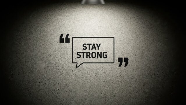 Stay Strong quote inside a speech bubble on a textured concrete wall with spotlight. Motivational concept for personal growth and mental resilience campaigns.