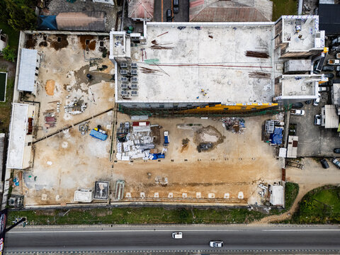 Aerial view of the NDDC CMS building under construction, showing the concrete structure, rooftop air conditioning units, and construction materials in Port Harcourt, Rivers, Nigeria.